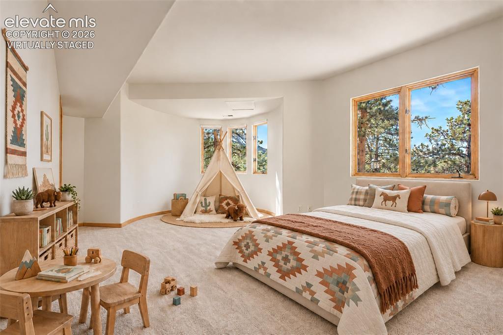 Image 38 of 50: Virtually Staged
Spacious room with large windows, light-toned carpeting,