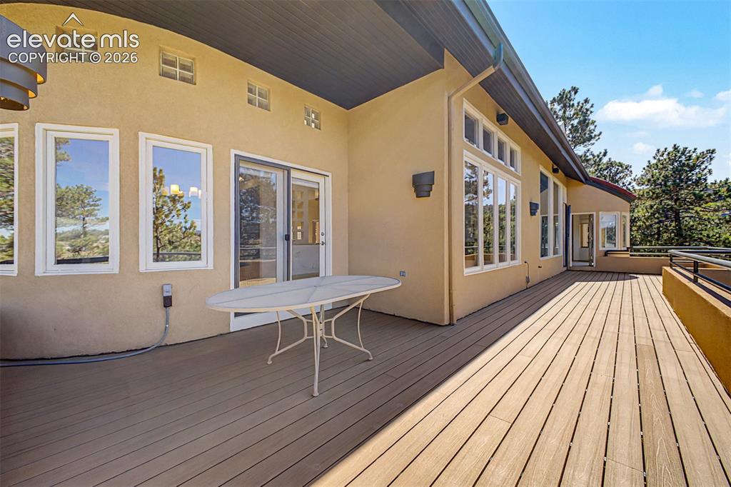 Image 48 of 50: Expansive outdoor deck featuring wood-finish flooring, stucco exterior, mul