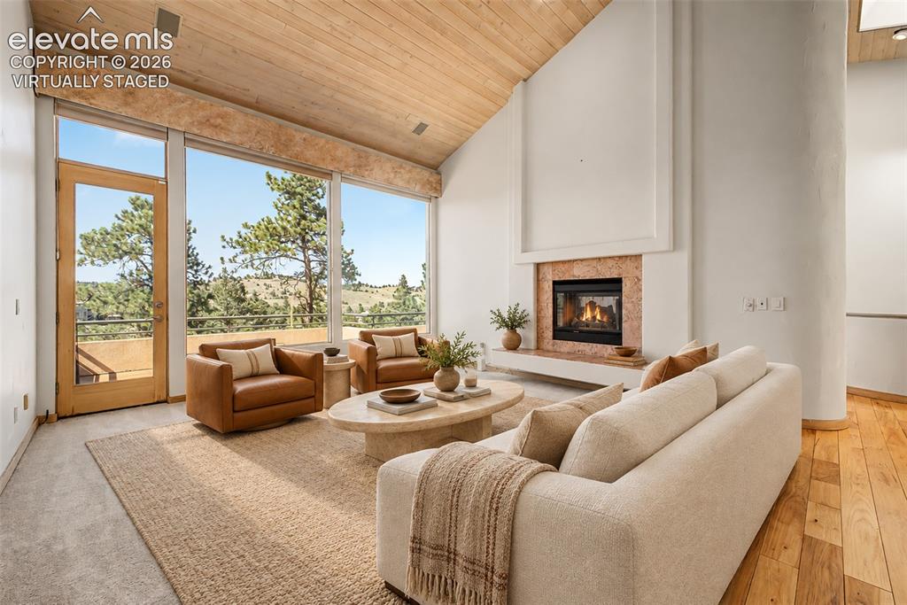 Image 5 of 50: Virtually Staged
Vaulted wood-paneled ceiling, large picture windows, wood