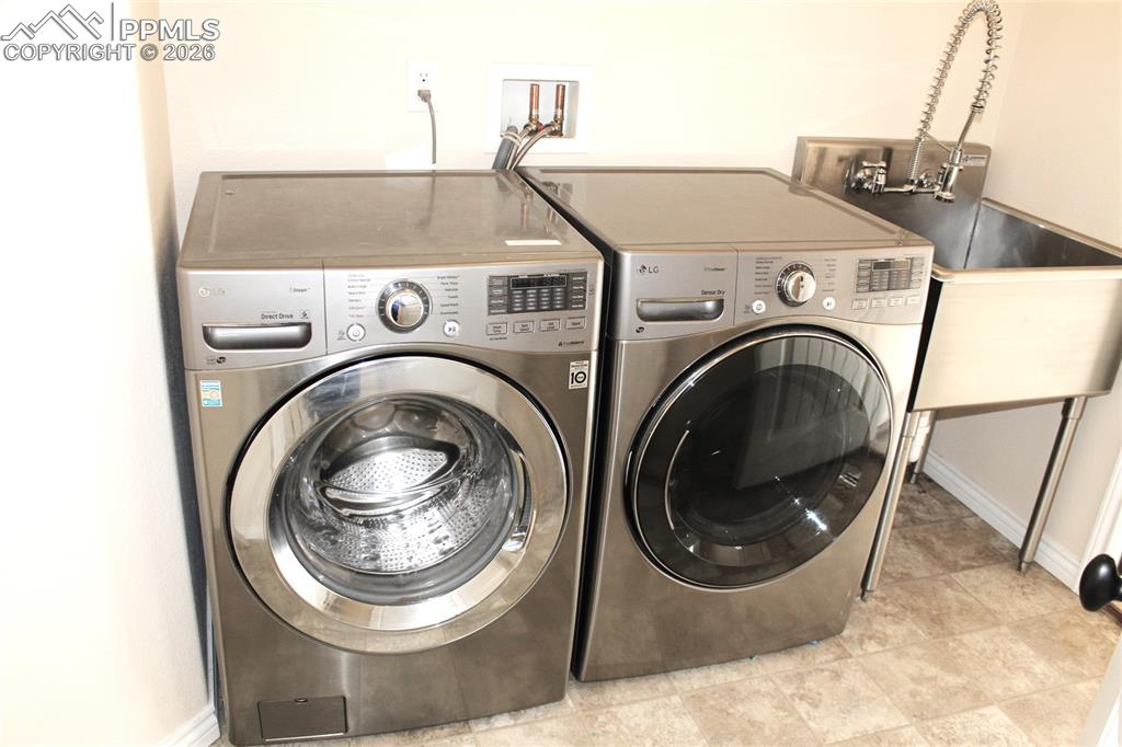Image 43 of 46: Washer, Dryer and Stainless Steel Sink