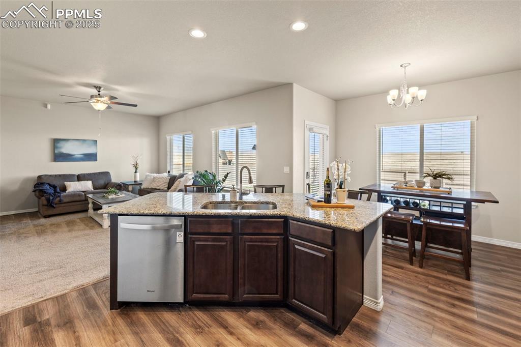 Image 11 of 36: Kitchen featuring a sink, dark wood finished floors, baseboards, stainless