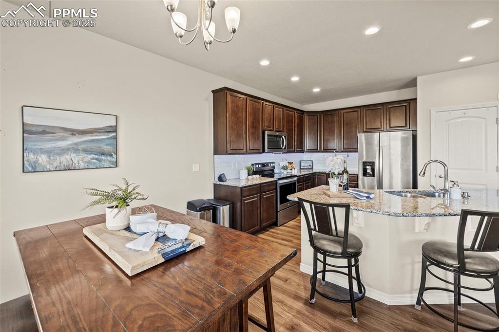 Image 15 of 36: Kitchen featuring a sink, appliances with stainless steel finishes, light w