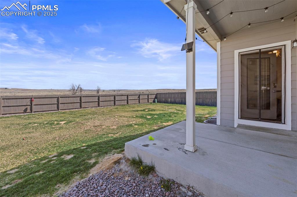 Image 32 of 36: View of yard featuring a patio and a fenced backyard