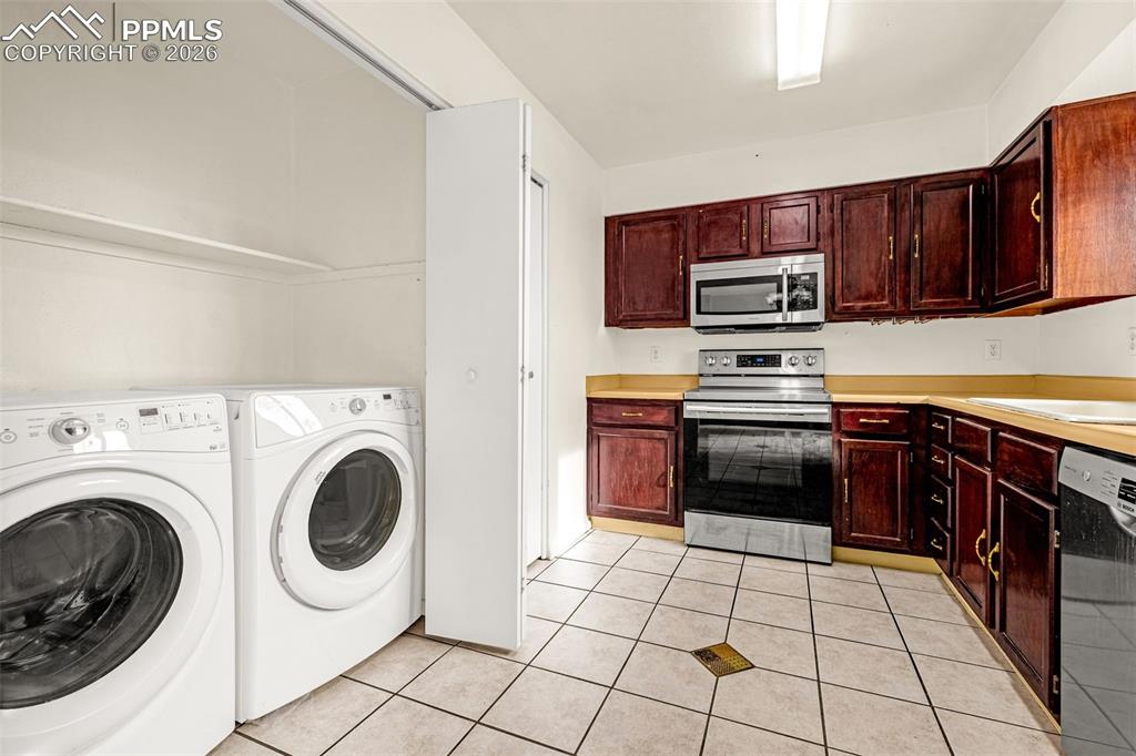 Image 11 of 21: Kitchen and laundry closet - newer appliances including Bosch SilencePlus d