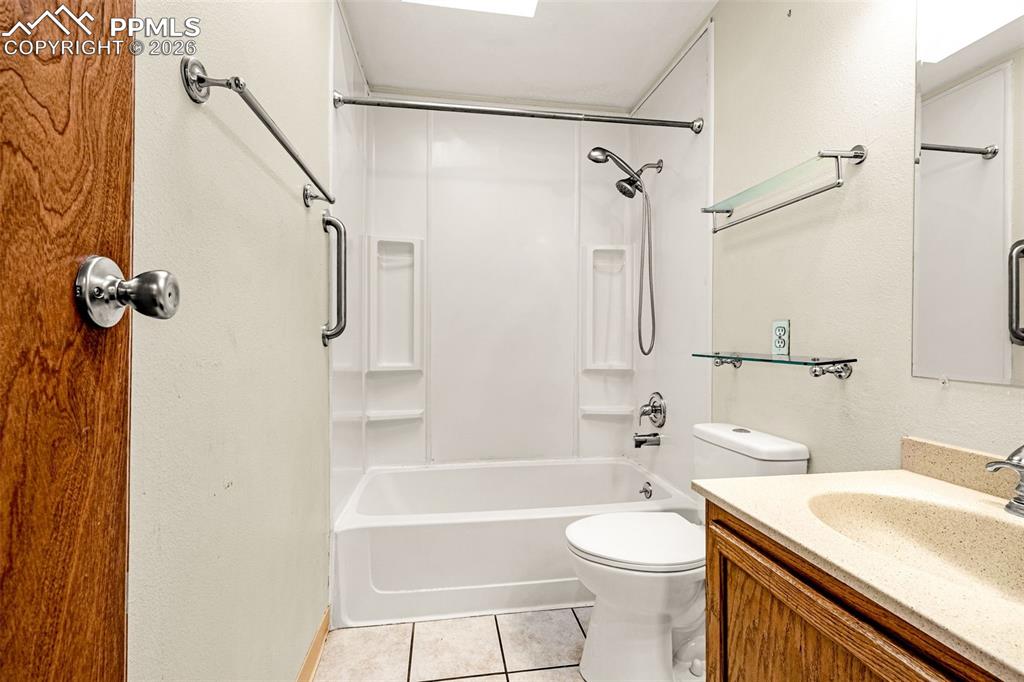 Image 17 of 21: Full bathroom with tub/shower combo, skylight and tile flooring
