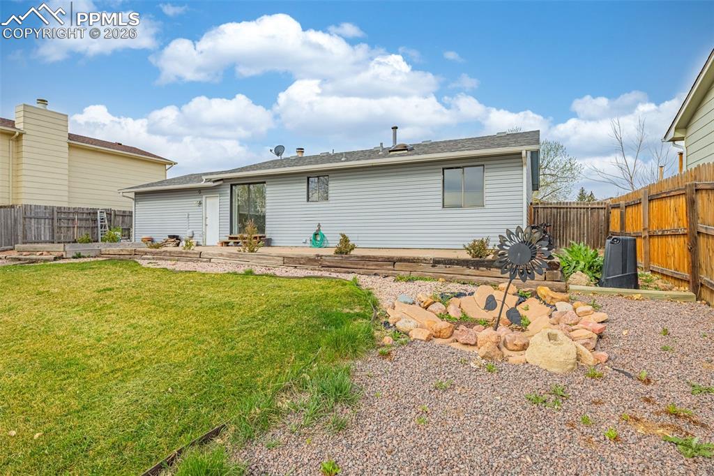 Image 19 of 21: Sliding glass door to back patio; door to garage