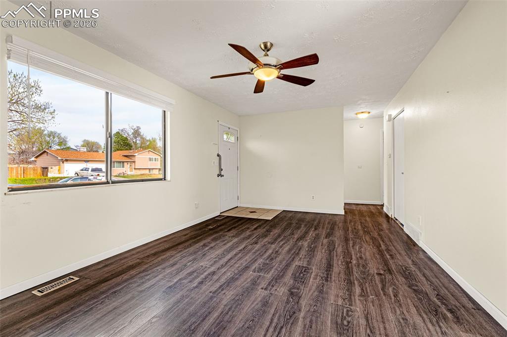 Image 5 of 21: Living room view from fireplace and hall to bedrooms and bathroom