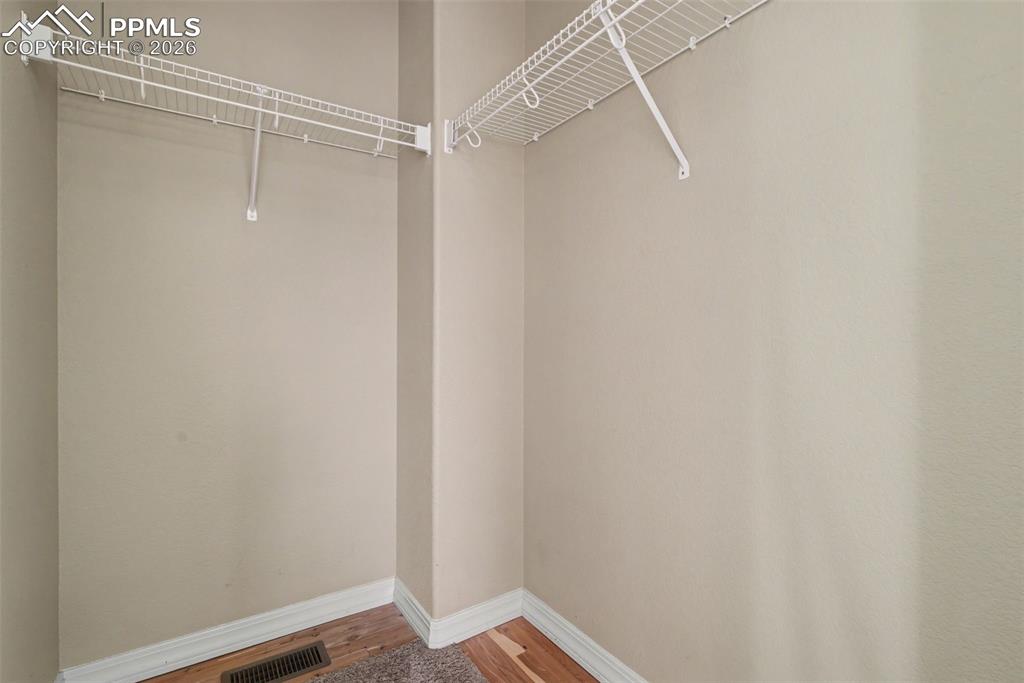 Image 27 of 49: HUGE Walk-in Closet w/Cedar Floor Accent