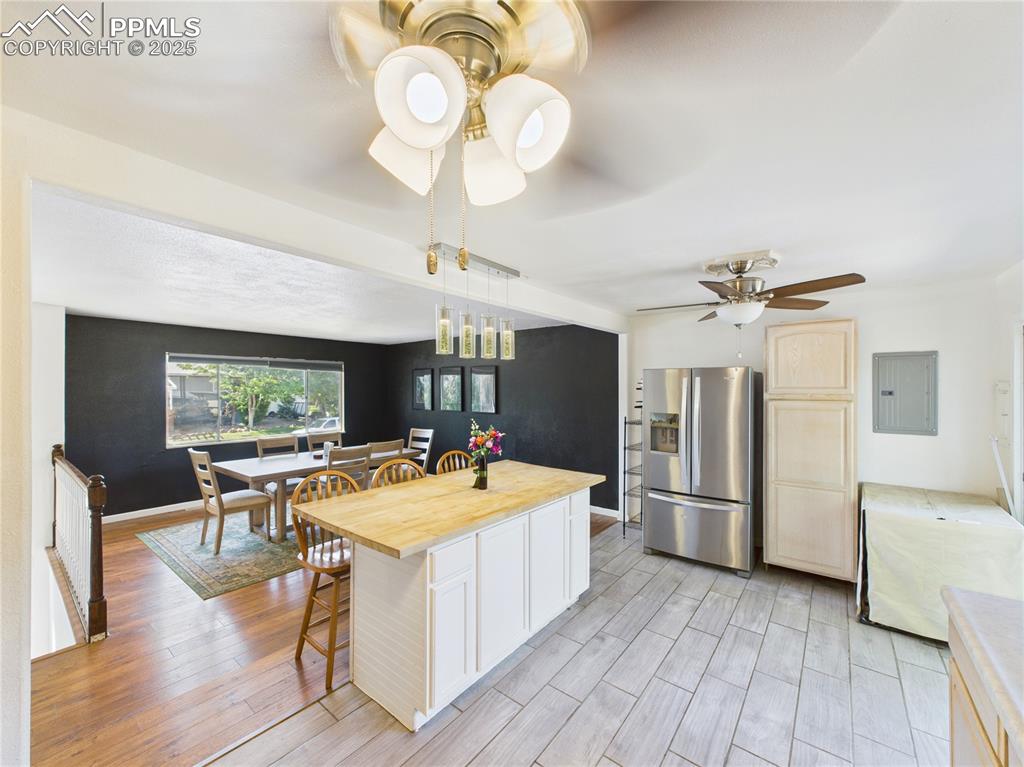 Image 14 of 41: Kitchen with stainless steel refrigerator with ice dispenser, electric pane