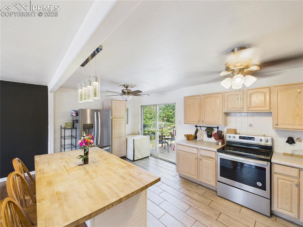 Image 15 of 41: Kitchen featuring appliances with stainless steel finishes, light brown cab