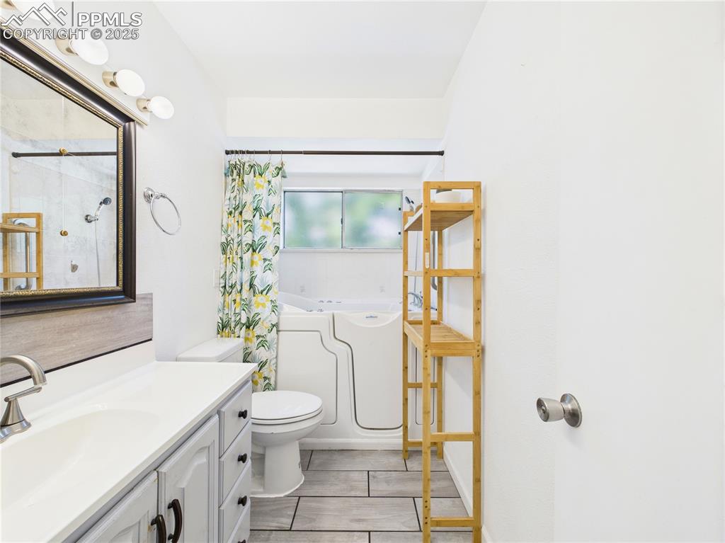 Image 18 of 41: Bathroom featuring vanity, a bathtub, and a shower