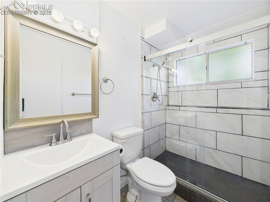 Image 28 of 41: Bathroom with a shower stall and vanity