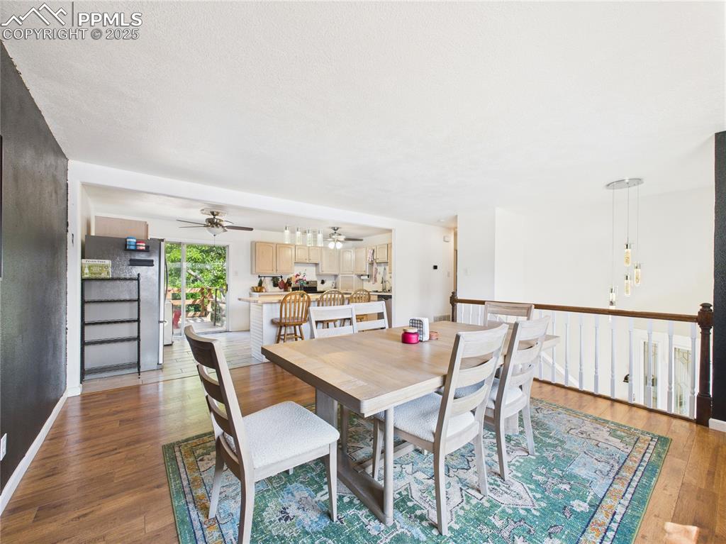 Image 6 of 41: Dining area featuring a ceiling fan and wood finished floors