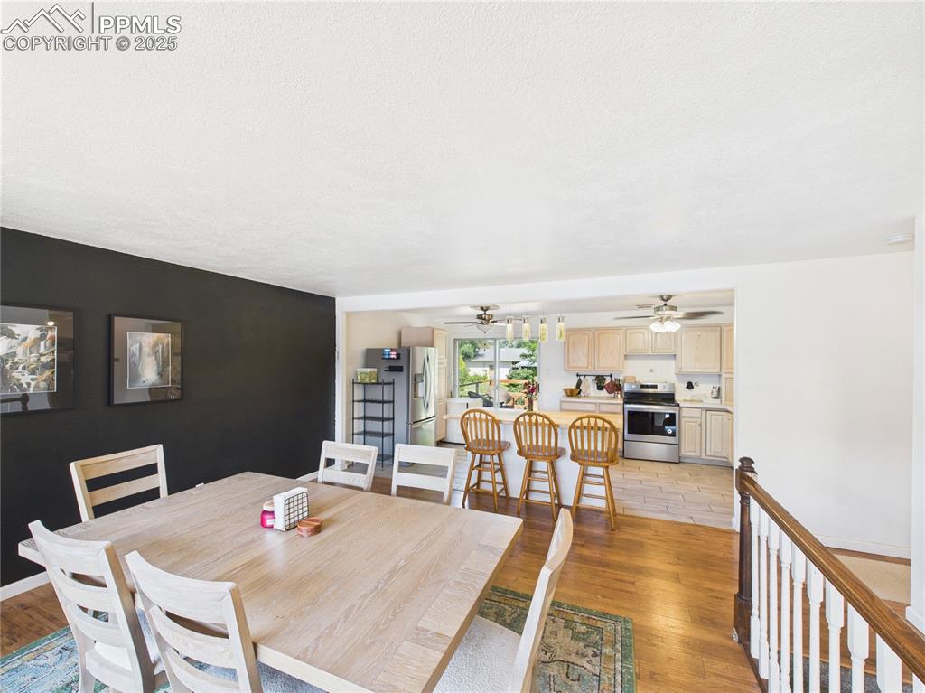 Image 7 of 41: Dining space featuring light wood-style floors, ceiling fan, and an accent 