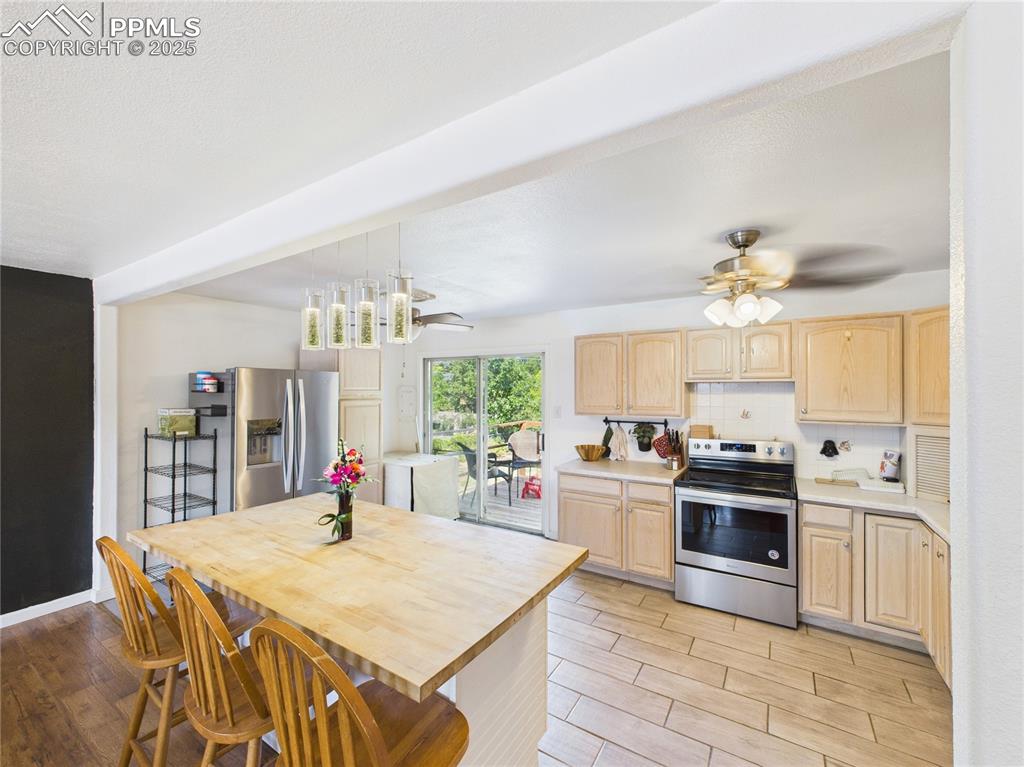 Image 8 of 41: Kitchen featuring appliances with stainless steel finishes, light brown cab