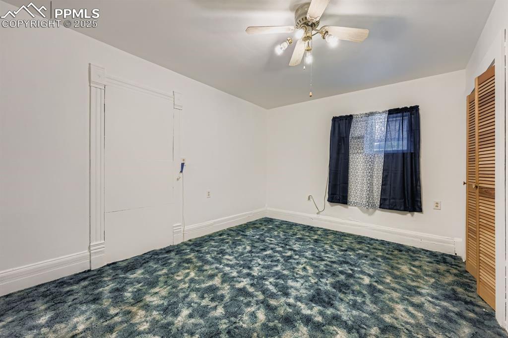 Image 15 of 28: Unfurnished bedroom with carpet flooring, ceiling fan, and a closet