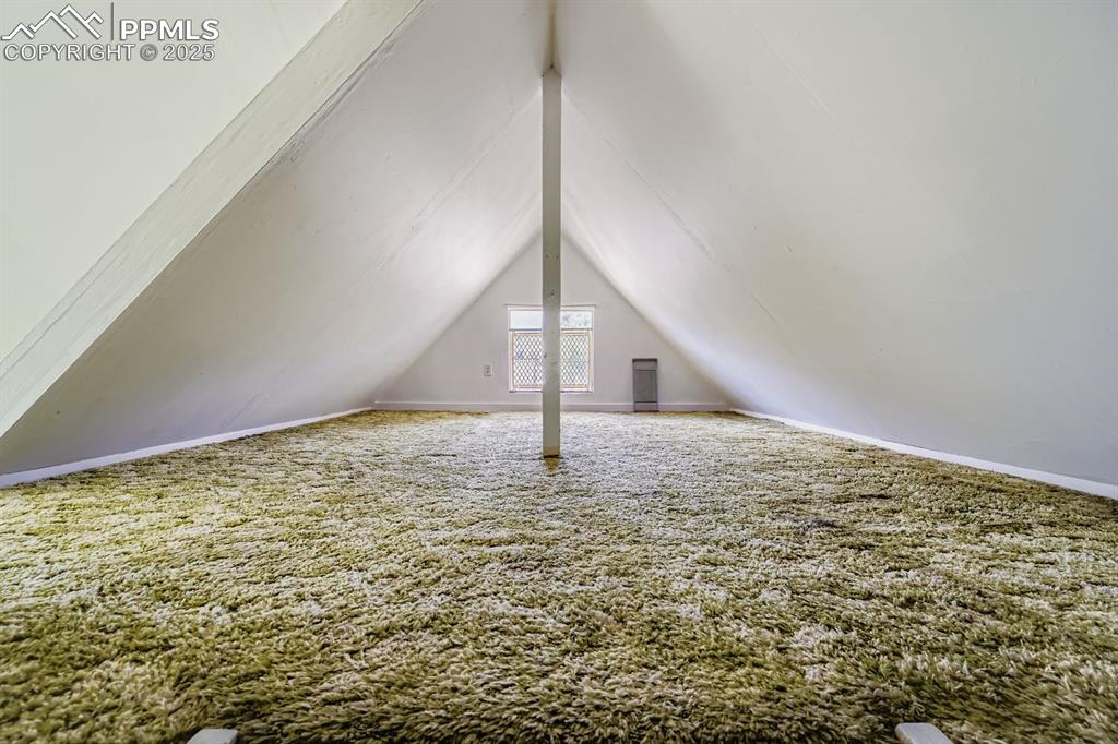 Image 23 of 28: Bonus room featuring carpet and vaulted ceiling