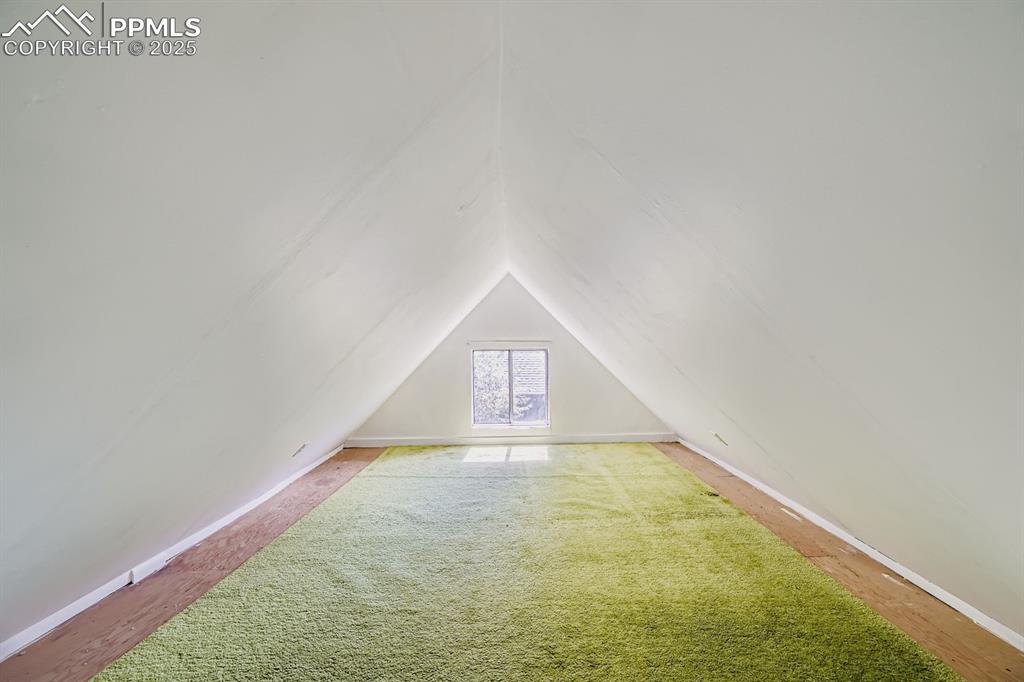 Image 24 of 28: Bonus room featuring wood finished floors and lofted ceiling