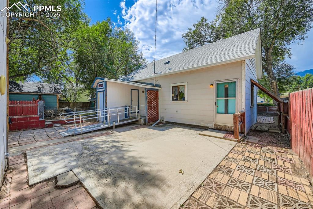 Image 28 of 28: Back of property featuring a patio area and a shingled roof