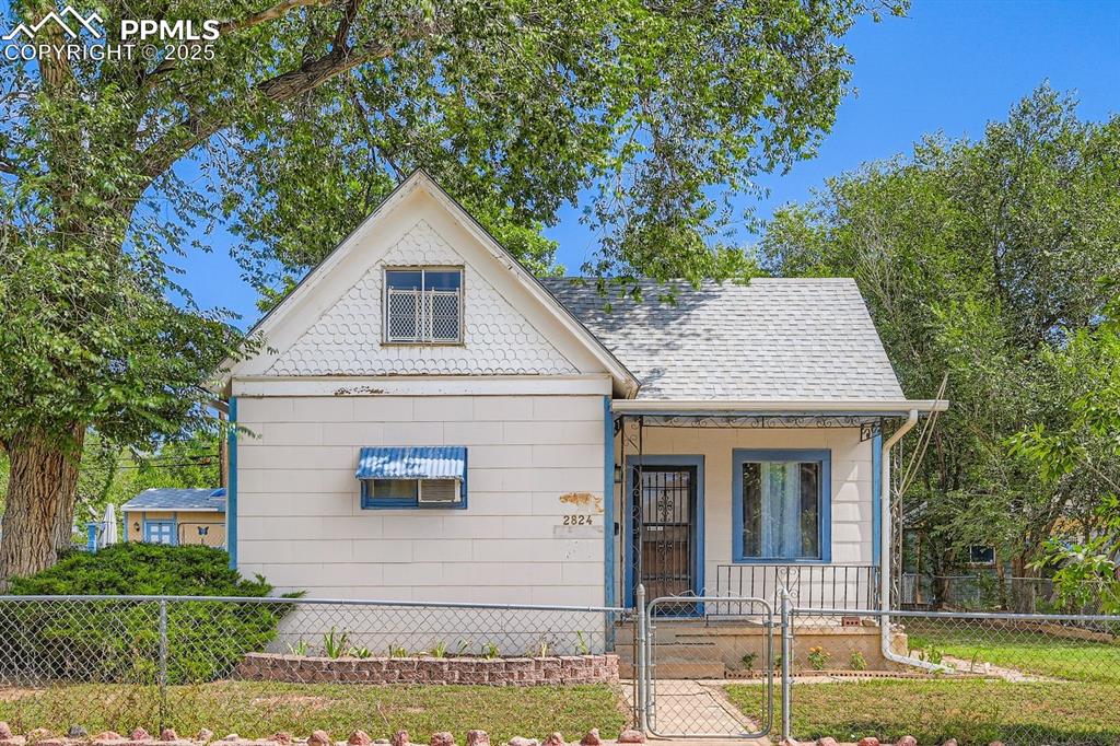 Image 3 of 28: View of front of house featuring a gate, a fenced front yard, a porch, and