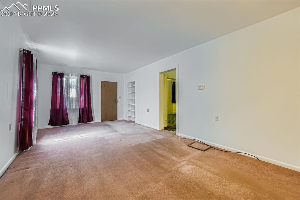 Image 6 of 28: Carpeted spare room with baseboards