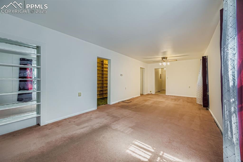 Image 8 of 28: Unfurnished living room featuring carpet and a ceiling fan