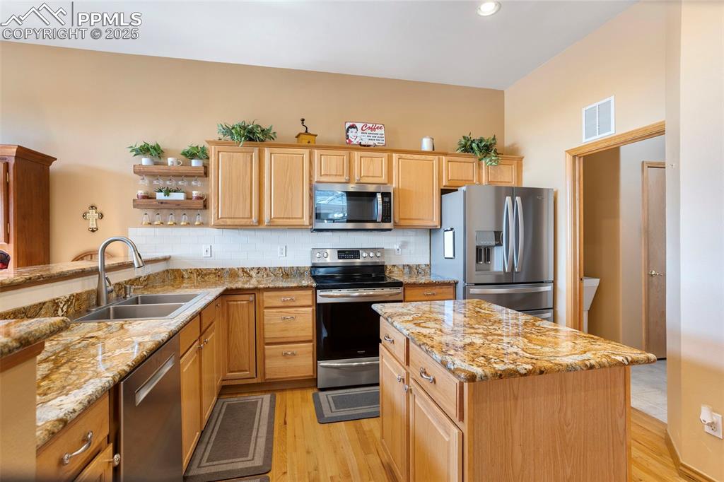 Image 10 of 33: The functional kitchen leads to the laundry room and on to the garage.