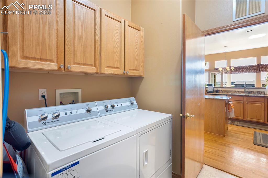 Image 14 of 33: The man level laundry is located off the kitchen and leads to the garage. W