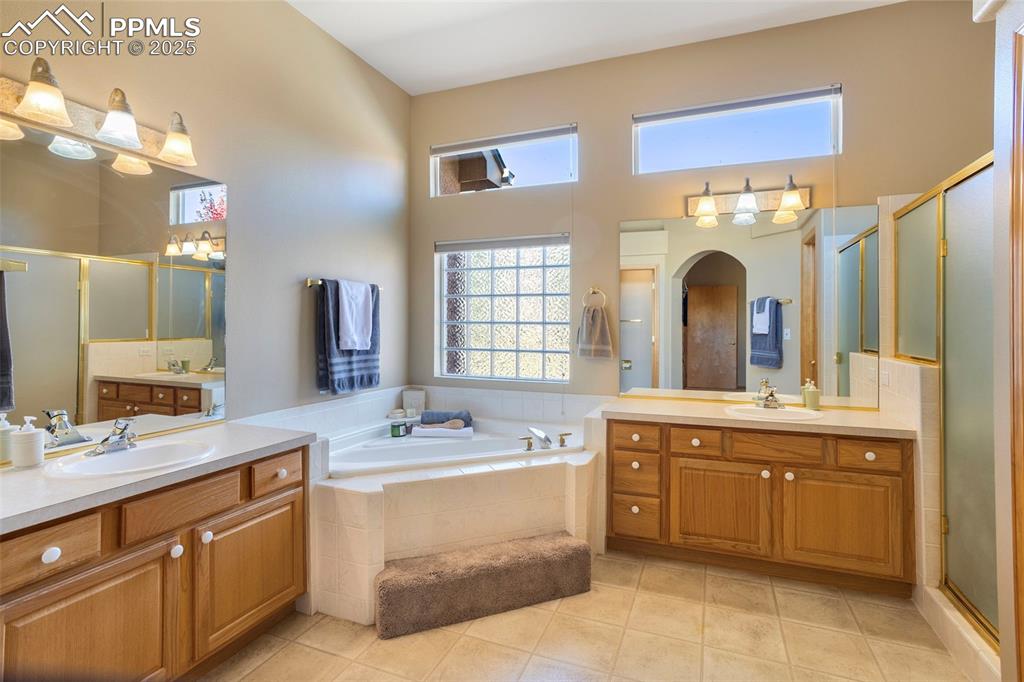 Image 18 of 33: The elegant 5-pc primary bath features double vanities, a jetted soaker tub