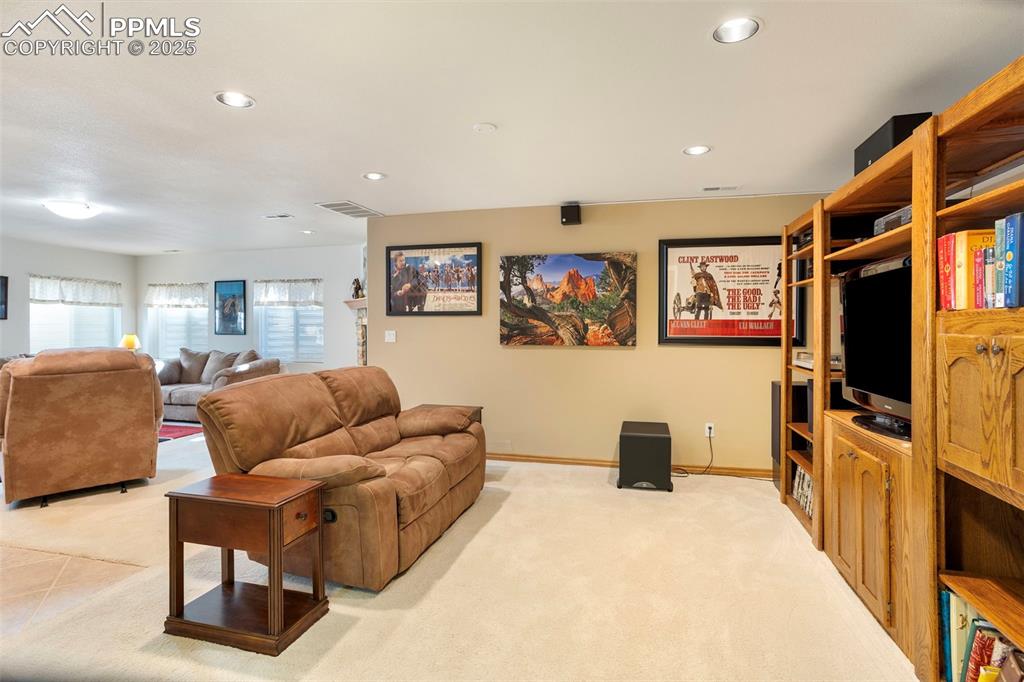Image 19 of 33: The basement family room offers additional living space for relaxing in fro