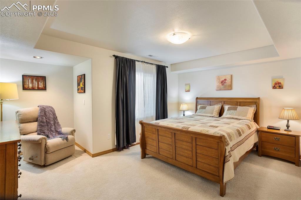Image 24 of 33: Spacious basement bedroom #2 features a coffered ceiling.