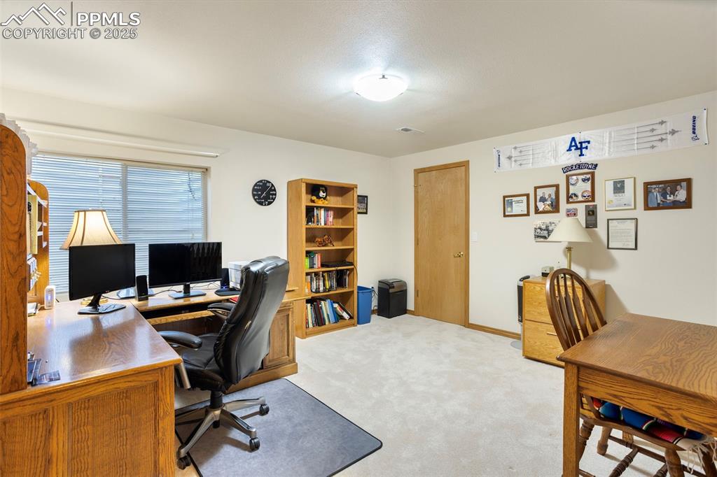 Image 27 of 33: Basement bedroom #3 is currently used as an office.
