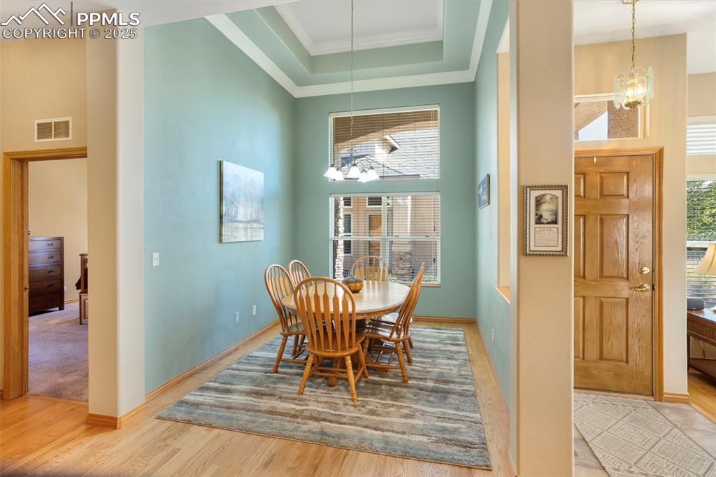Image 5 of 33: A coffered, cathedral ceiling adds a touch of elegance to the formal dining
