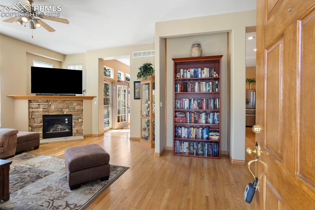 Image 6 of 33: Upon entry, you are greeted with a view of the beautiful stone fireplace in
