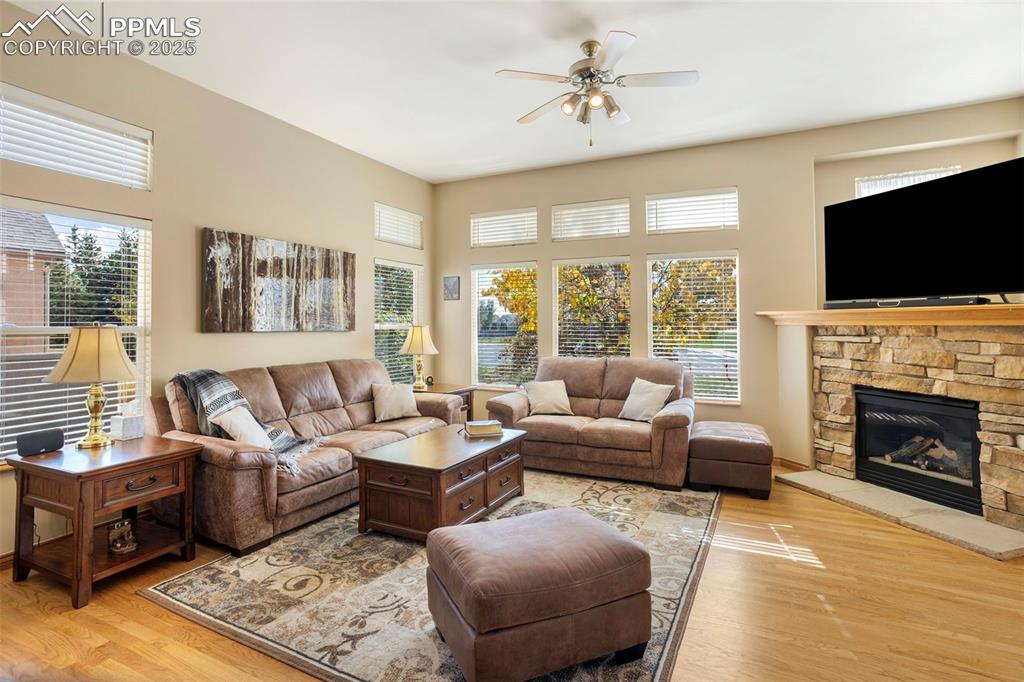 Image 7 of 33: The great room is so inviting with its natural light, cozy fireplace and wa