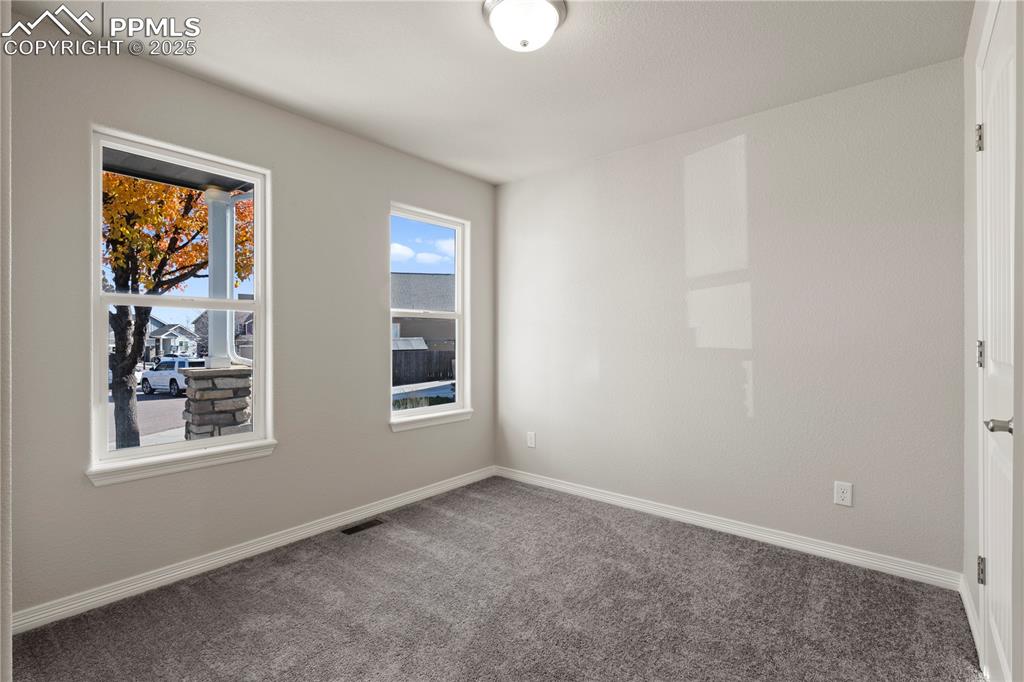 Image 11 of 35: Carpeted spare room featuring baseboards