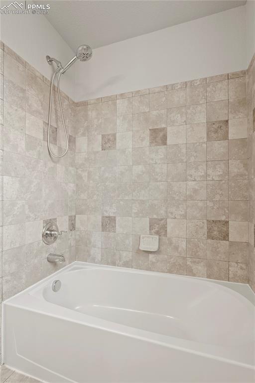 Image 15 of 35: Bathroom featuring shower / washtub combination