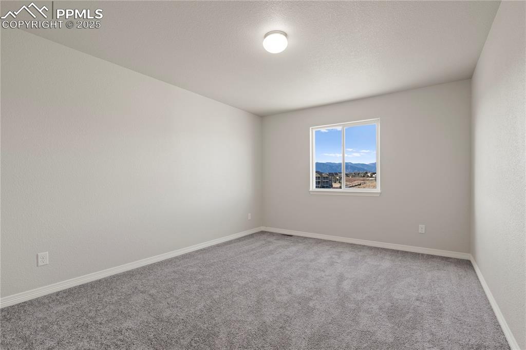 Image 24 of 35: Unfurnished room with carpet flooring and a mountain view