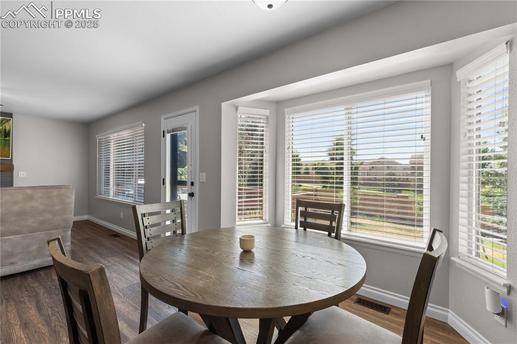 Image 11 of 31: Dining room featuring wood finished floors and baseboards