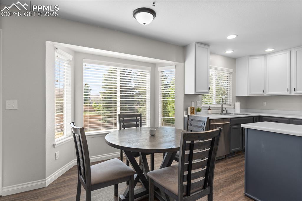 Image 12 of 31: Dining space featuring dark wood-type flooring, plenty of natural light, an