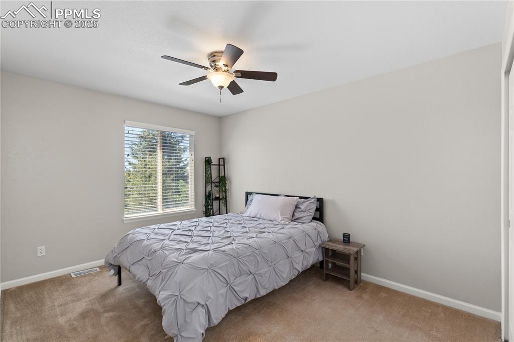 Image 17 of 31: Bedroom with carpet and a ceiling fan