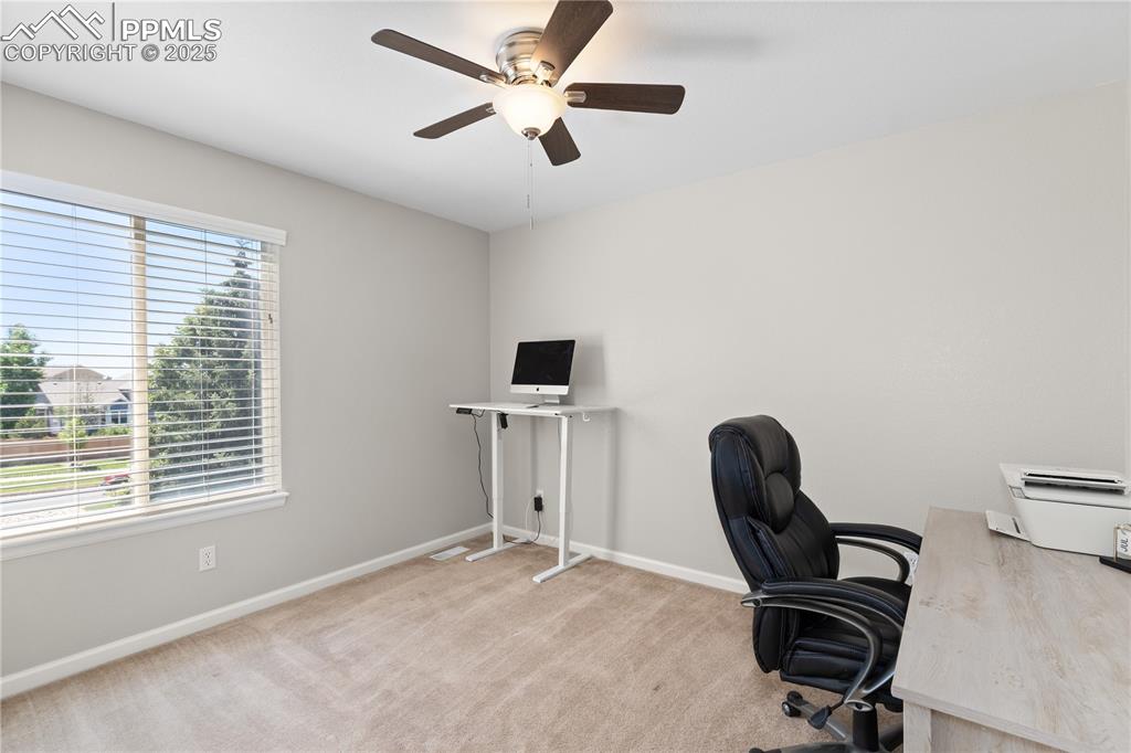 Image 19 of 31: Unfurnished office featuring a ceiling fan and carpet