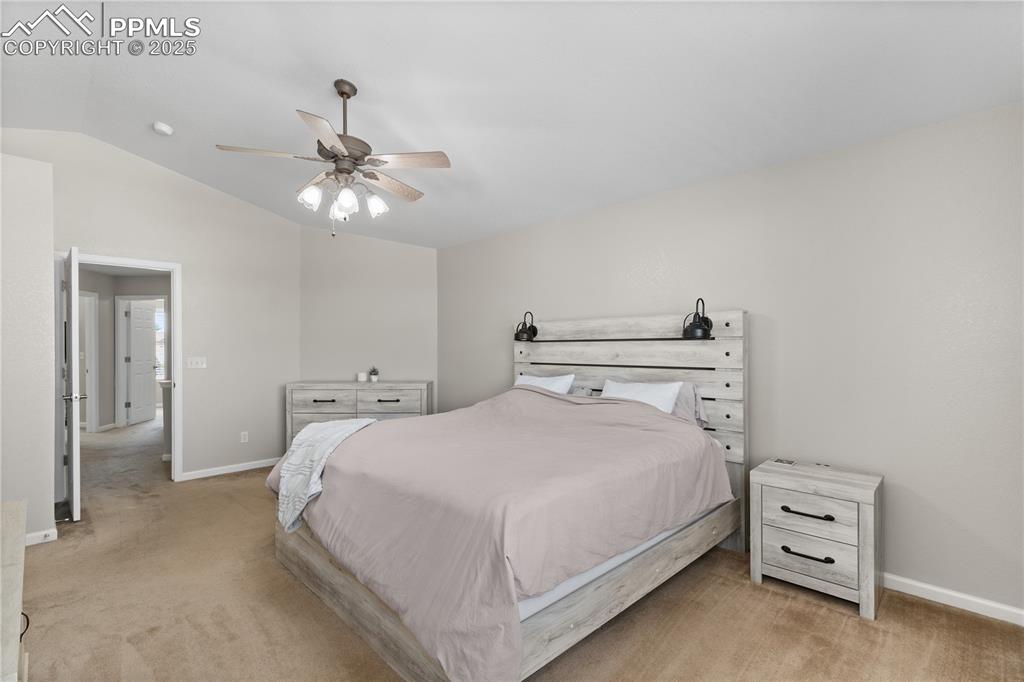 Image 24 of 31: Bedroom with light carpet, lofted ceiling, and ceiling fan