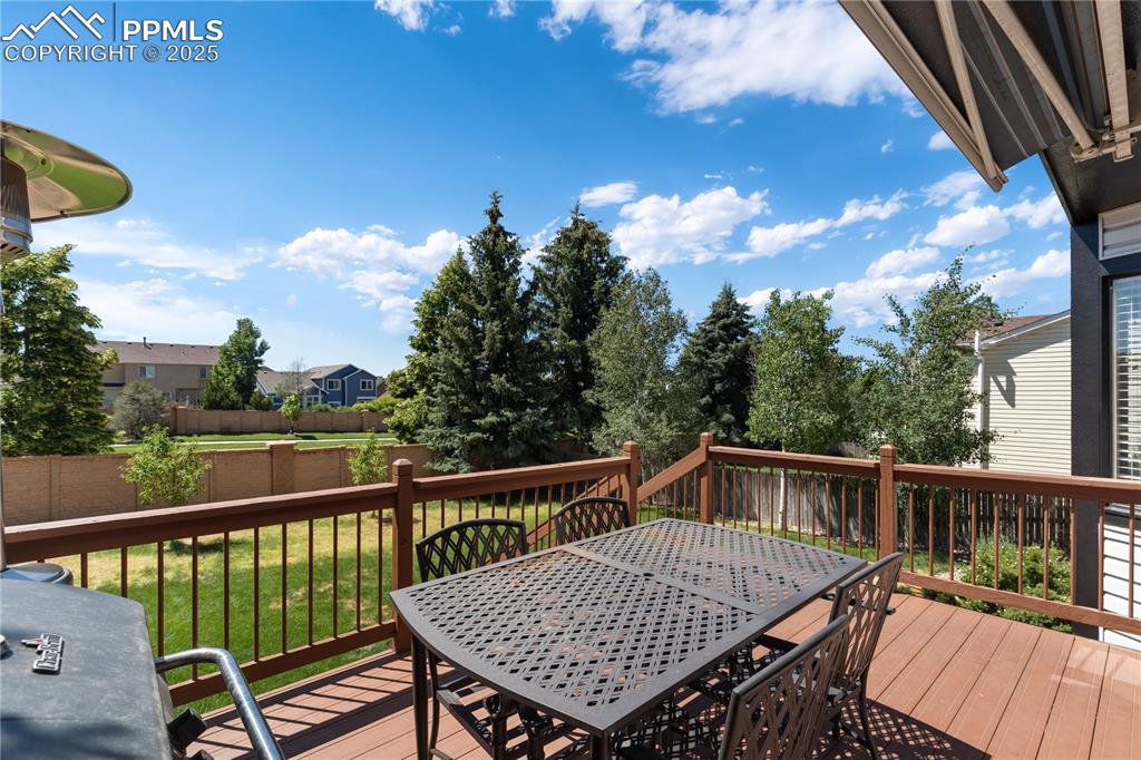 Image 28 of 31: Wooden deck with outdoor dining space