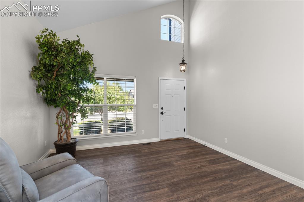 Image 5 of 31: Entryway with dark wood-style flooring and a high ceiling