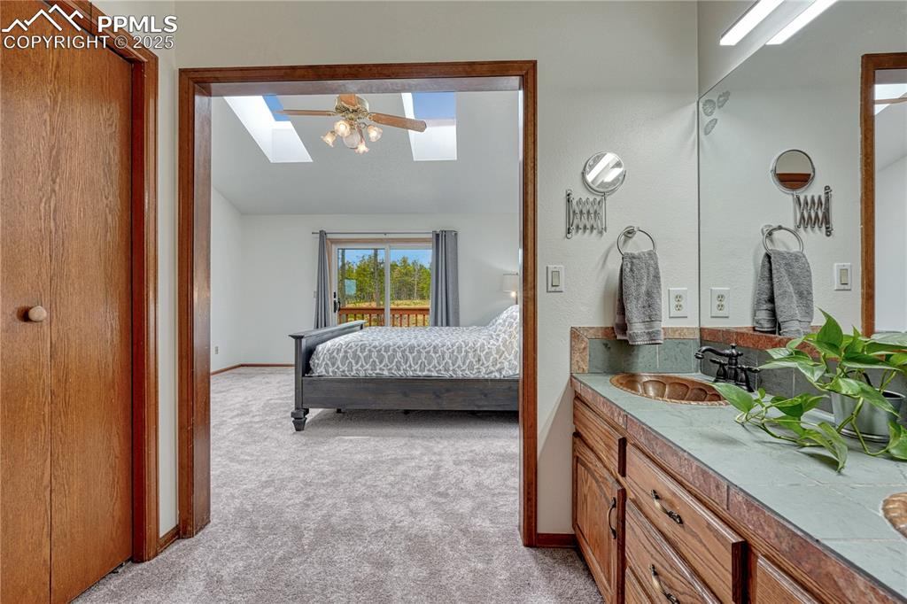 Image 16 of 48: Primary bedroom & bathroom