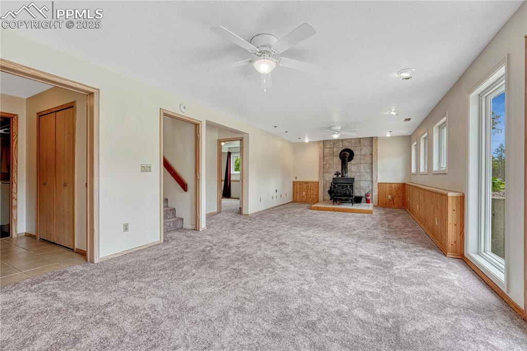 Image 20 of 48: Walk-out basement with wood stove & new carpets