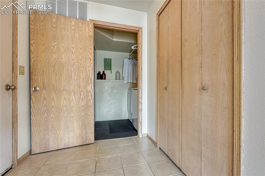 Image 28 of 48: Mudroom entrance from garage & laundry room