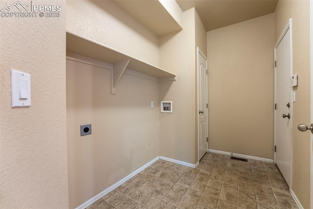 Image 13 of 49: Washroom featuring hookup for a washing machine and electric dryer hookup
