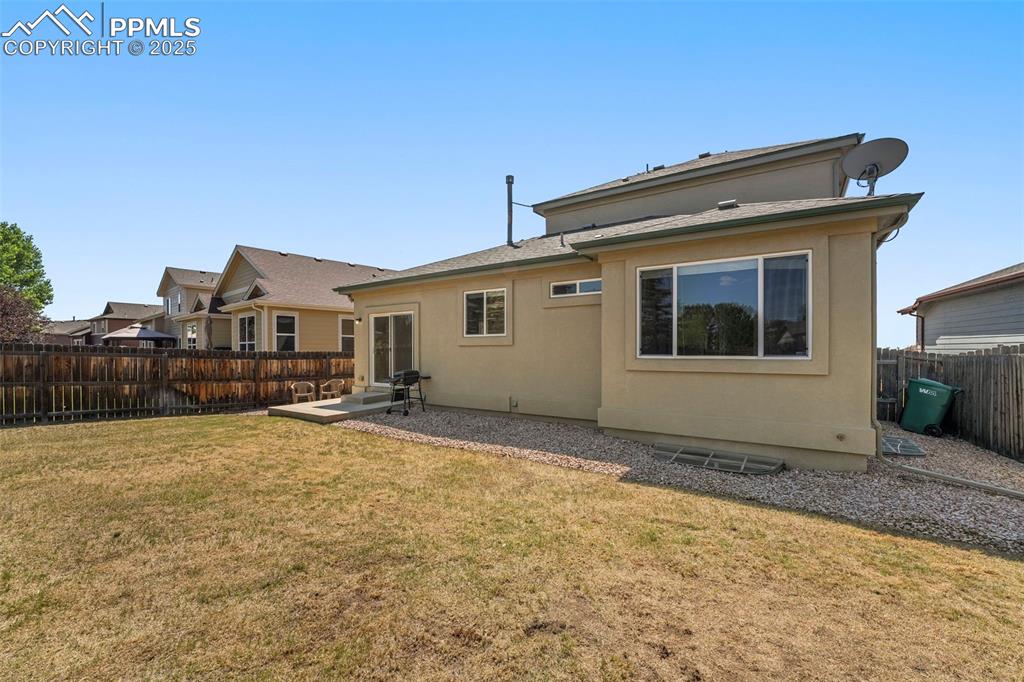 Image 37 of 49: Rear view of property with a fenced backyard